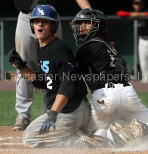 SWS's Jake Howells and Lancaster catcher Michael Morales look for the call after Howells slides home safely. (Chris Knight photo) 