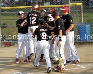 Warwick's Zach Shertzer is greeted at home after his home run. (Kirk Neidermyer photo)