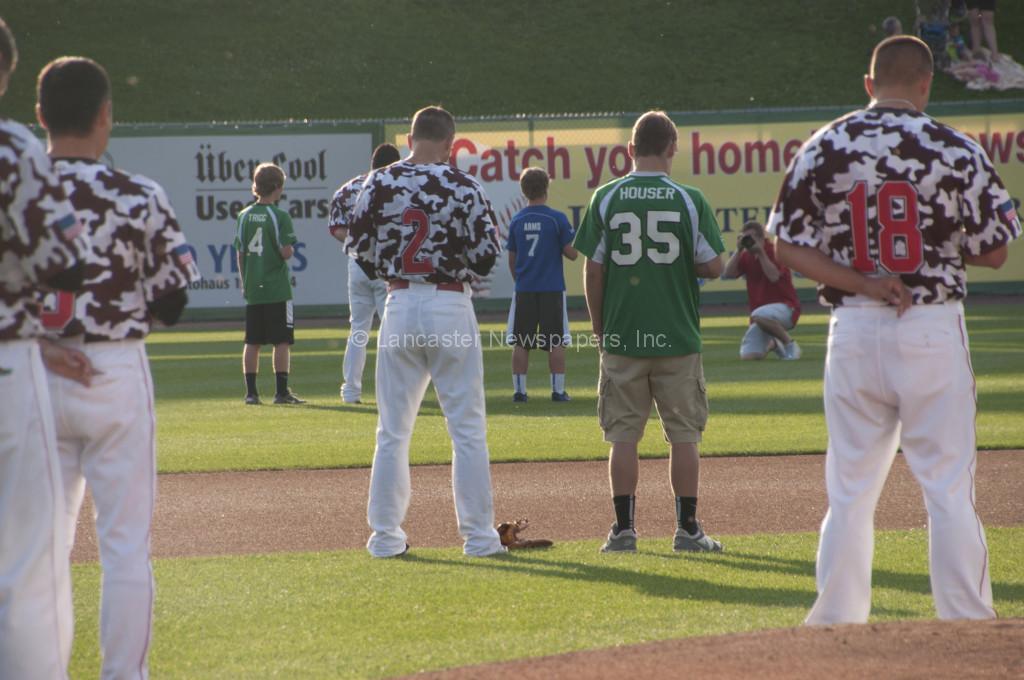 Players from the New Era championship teams join the Barnstormers on the field during the national anthem. (Brian Leid photo)