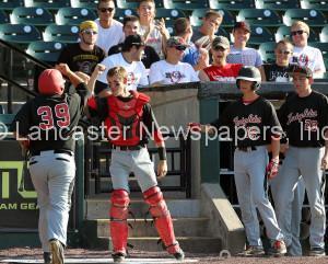 Hempfield Black's bench congratulates teammate Angel Colon (39) after he scored against Strasburg Willow Street during 3rd inning action of an LNP Tournament quarterfinal game at Clipper Magazine Stadium in Lancaster Wednesday July 22, 2015.(Photo/Chris Knight)