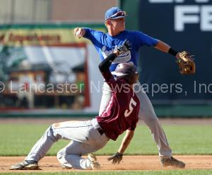 Manheim VFW's Bryce Eberly (5) is out as Garden Spot shortstop Brock Kauffman (00) tries to turn the double play during 1st inning action of an LNP Tournament Midget Quarterfinal game at Clipper Magazine Stadium in Lancaster Thursday July 23, 2015.(Photo/Chris Knight)