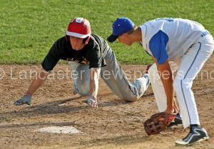 Hempfield Black's Tanner Seitz (14) scores on a past ball as Cocalico pitcher Tyler Strickler (4) comes up to cover the plate during 6th inning action of an LNP Tournament Midget Semifinal game at Clipper Magazine Stadium in Lancaster Friday July 24, 2015.(Photo/Chris Knight)