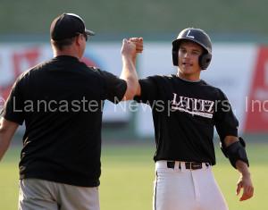 Lititz Oddfellows Nate Hess (17) gets a bump from coach after a triple against Cocalico during 1st inning action of an LNP Tournament Midget Championship game at Clipper Magazine Stadium in Lancaster Sunday July 26, 2015.(Photo/Chris Knight)