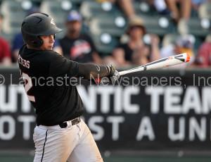 Lititz Oddfellows Zach Peters (12) belts a 3 run single against Cocalico during 6th inning action of an LNP Tournament Midget Championship game at Clipper Magazine Stadium in Lancaster Sunday July 26, 2015.(Photo/Chris Knight)